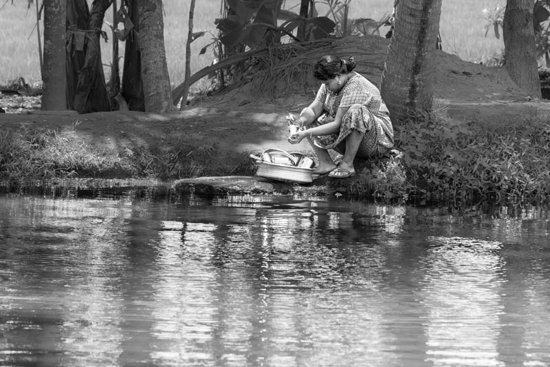 Living Below the Sea Level - Cleaning utensils along the banks of a channel of Pamba river in Alappuzha district, Kerala